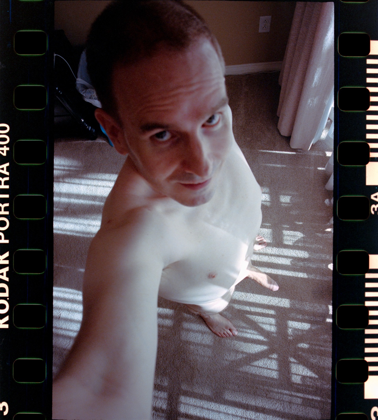 35mm Kodak Portra 400 selfie of SJ Nude at home in San Jose, film rebate in the scan