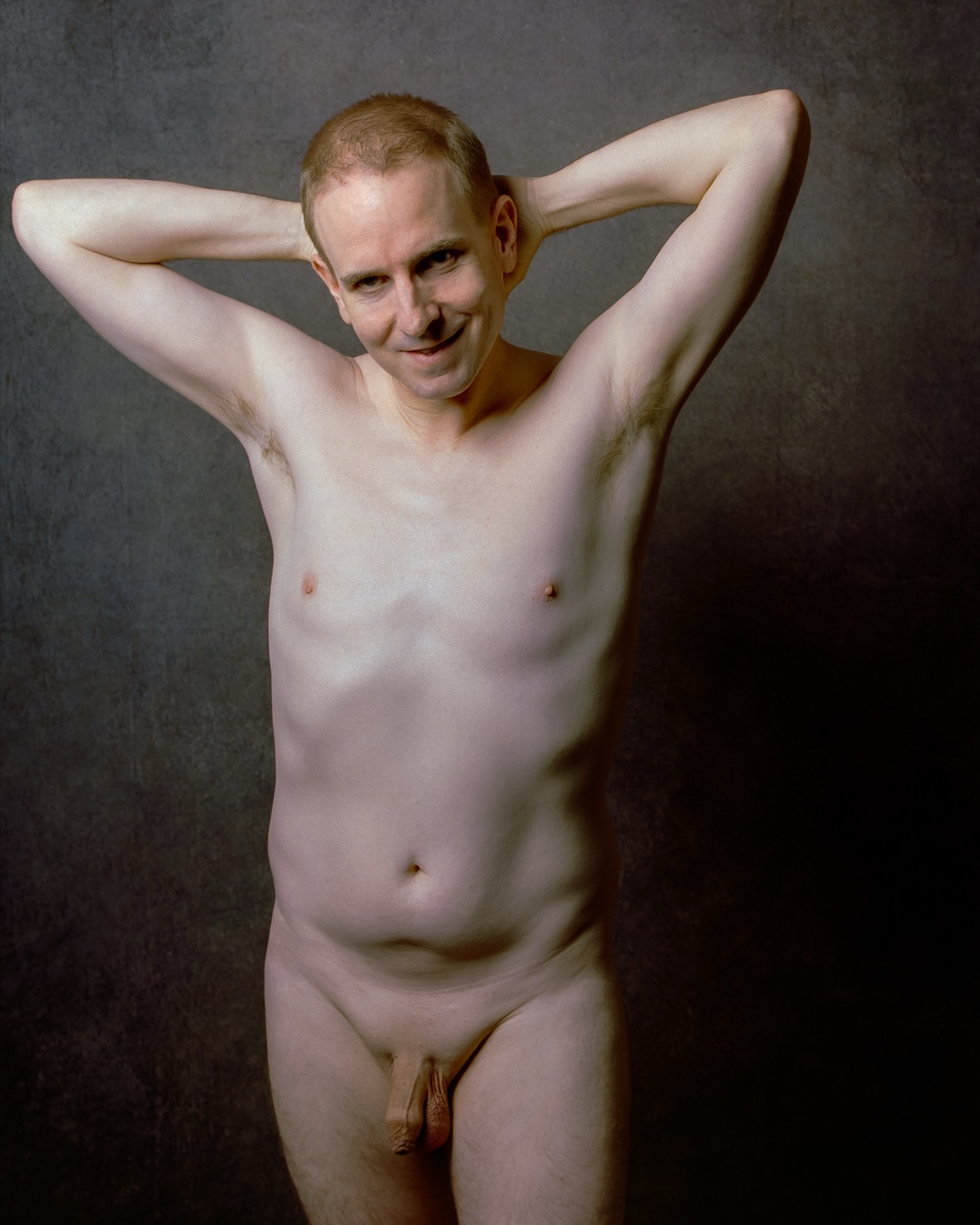 SJ Nude standing fully nude with hands behind his head, gray backdrop, medium format Kodak Portra 400, San Jose