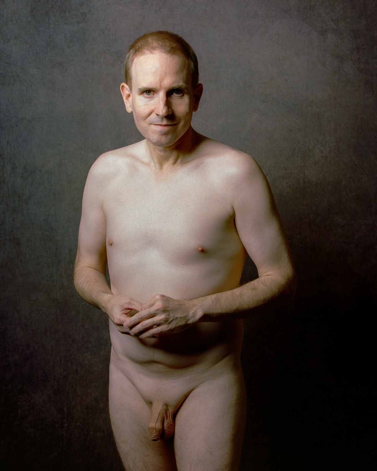 SJ Nude standing fully nude with hands at his waist, gray backdrop, Kodak Portra 400, San Jose